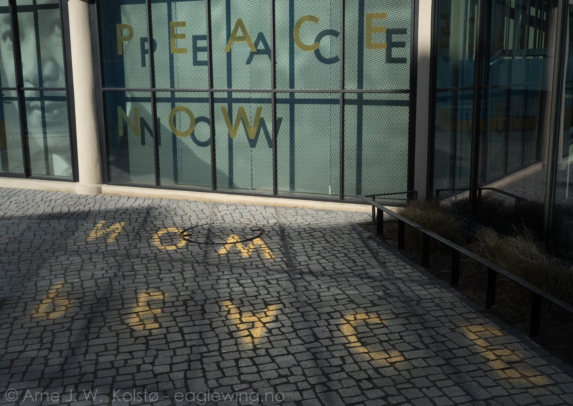  The golden letters in the window reflect the sun to the ground. ... - Oslo Peace Centre 
